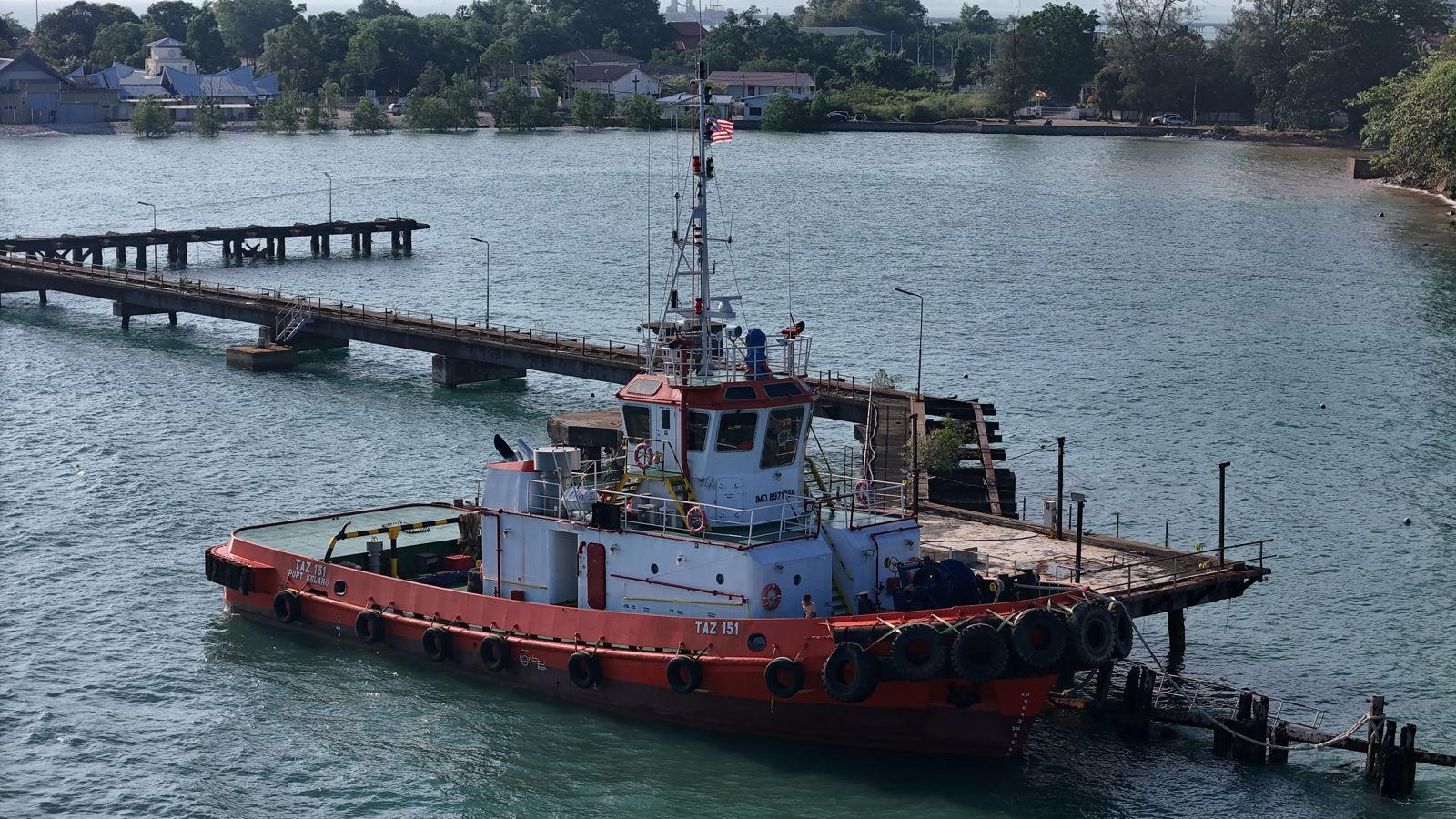 Tug moored alongside a jetty in Port Dickson