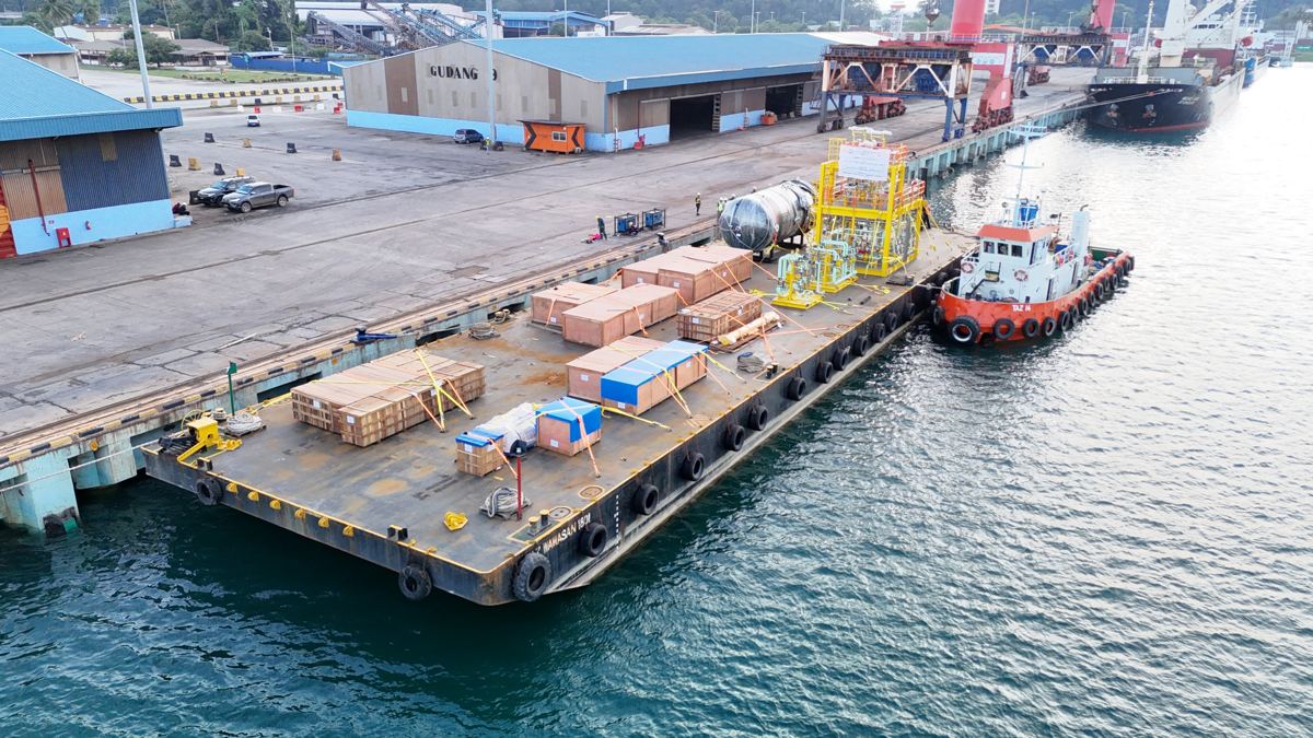 Cargo staged on a barge at the quayside